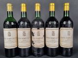 four bottles of wine are lined up in a row