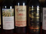 several bottles of wine are lined up in a row on a table