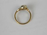 a close up of a gold ring with a pearl on it