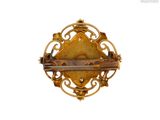 an image of a gold broochle on a white background