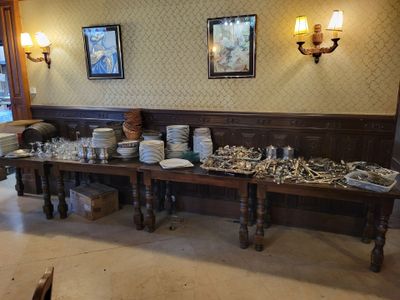 a long table with many plates and bowls on it