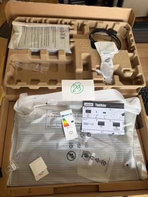 a box of eggs sitting on a desk with a keyboard