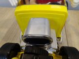 a yellow toy car with a mickey mouse figure in it