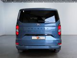 the back of a blue van is parked in a garage
