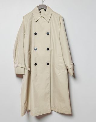 an image of a beige trench coat hanging on a hanger