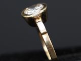 a close up of a gold ring with a diamond in it
