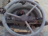 a steering wheel of a military vehicle with a clock on it