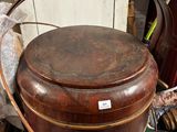 a large wooden bucket sitting on top of a green box