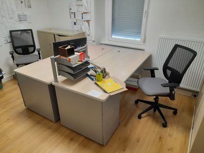a desk with a chair and a computer on it