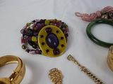 many different types of jewelry on a white table