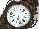 a large ornate clock with roman numerals on it