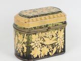 une petite boîte noire et jaune décorée de fleurs
