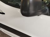 a side view mirror of a white car in a garage