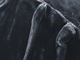 a close up of a black jacket with a tie on it