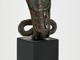 statue of a snake on a pedestal with a white background