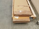 a pile of cardboard sitting on the floor next to a carton