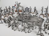 silver figurines of soldiers and soldiers on a white background
