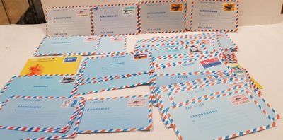 a table topped with lots of postcards and envelopes on top of it