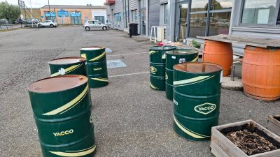 many barrels that are sitting in the parking lot