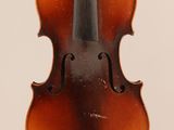 an old violin with a bow hanging from it ' s neck