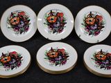 six plates with a picture of a cat and flowers on them