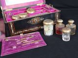a small box with a mirror and a few bottles of perfume
