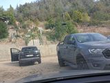 two cars that are parked on the side of the road