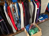 many different colored shirts hanging on a rack in a store
