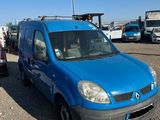 a blue van that is parked in a parking lot