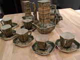 a lot of cups and saucers on the table