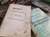 two books that are sitting on a table next to some tools