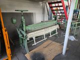 a machine that is working on a piece of wood