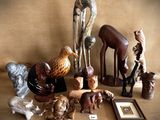 a lot of wooden animals that are on a table