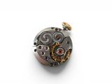 an image of a close up of a watch movement on a white surface