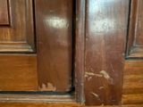 a cat that is sitting on the floor in front of a door