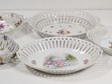 several bowls and bowls are lined up on a white surface