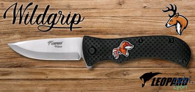 a close up of a knife on top of a wooden table