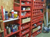 a room with a bunch of shelves and bins on the floor