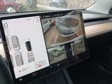 a car dashboard with a monitor and a steering wheel