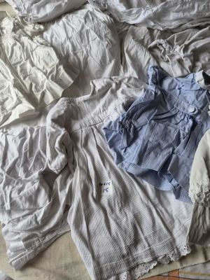 a bed with a lot of clothes on it