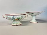 pair of porcelain bowls with floral designs on them on a white surface
