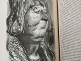 drawing of a woman in profile in a book with an open page