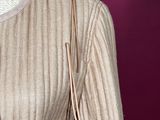 an image of a mannequin wearing a sweater and necklace