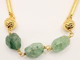 gold plated necklace with green stone beads and a gold chain