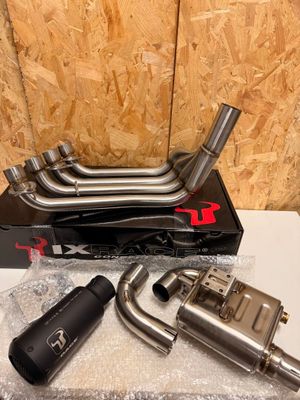 a couple of exhaust pipes sitting on top of a box