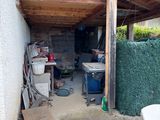 an image of a backyard area with a couch and a table