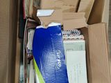 a cardboard box full of mails and other items