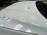 a white car parked in a parking lot next to a building