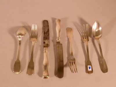 a lot of silver spoons and forks on the table