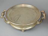 a silver plate with a handle and a bowl with handles